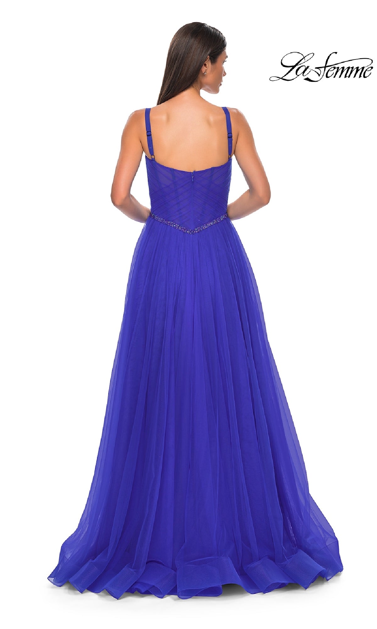 A woman is shown from the back wearing the La Femme 32956 beaded-waist long prom ball gown. The royal blue, sleeveless A-line dress features thin straps, a fitted bodice, and a flowing skirt. The La Femme logo appears in the top right corner.